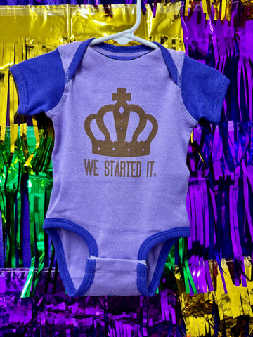 We Started It® Onesie